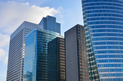 Photo of Exterior of different modern skyscrapers against blue sky