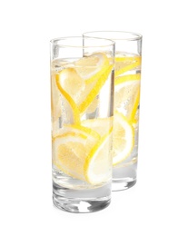 Soda water with lemon slices on white background