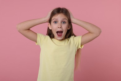 Photo of Portrait of surprised girl on pink background