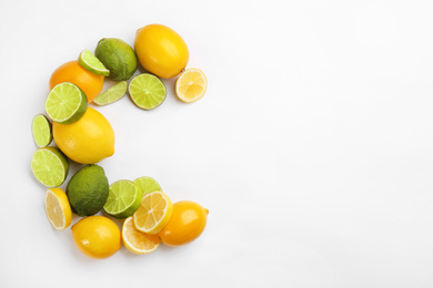 Photo of Letter C made with citrus fruits on white background as vitamin representation, top view