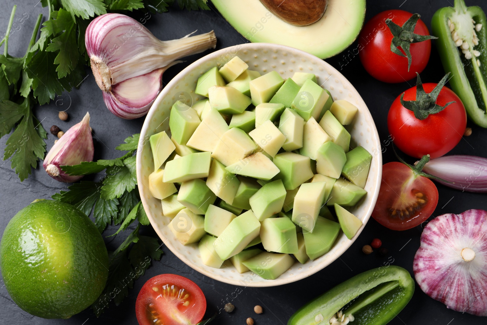 Photo of Fresh ingredients for guacamole on black table, flat lay