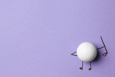 Photo of White ball as golf player on lilac background - creative image. Top view