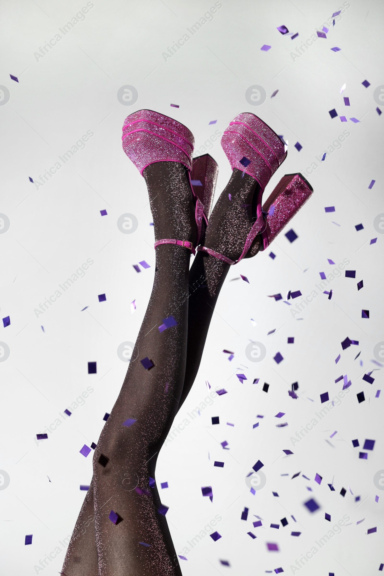 Photo of Stylish party. Woman wearing pink high heeled shoes with platform and square toes on light grey background, closeup