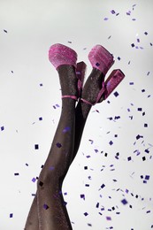 Photo of Stylish party. Woman wearing pink high heeled shoes with platform and square toes on light grey background, closeup