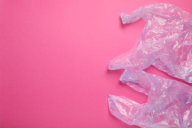 Photo of Plastic bags on pink background, top view. Space for text