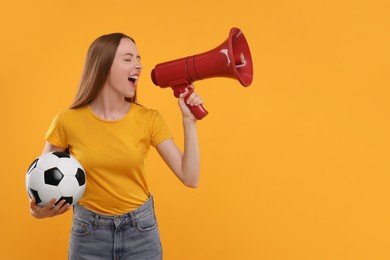 Photo of Emotional sports fan with ball and megaphone on yellow background. Space for text