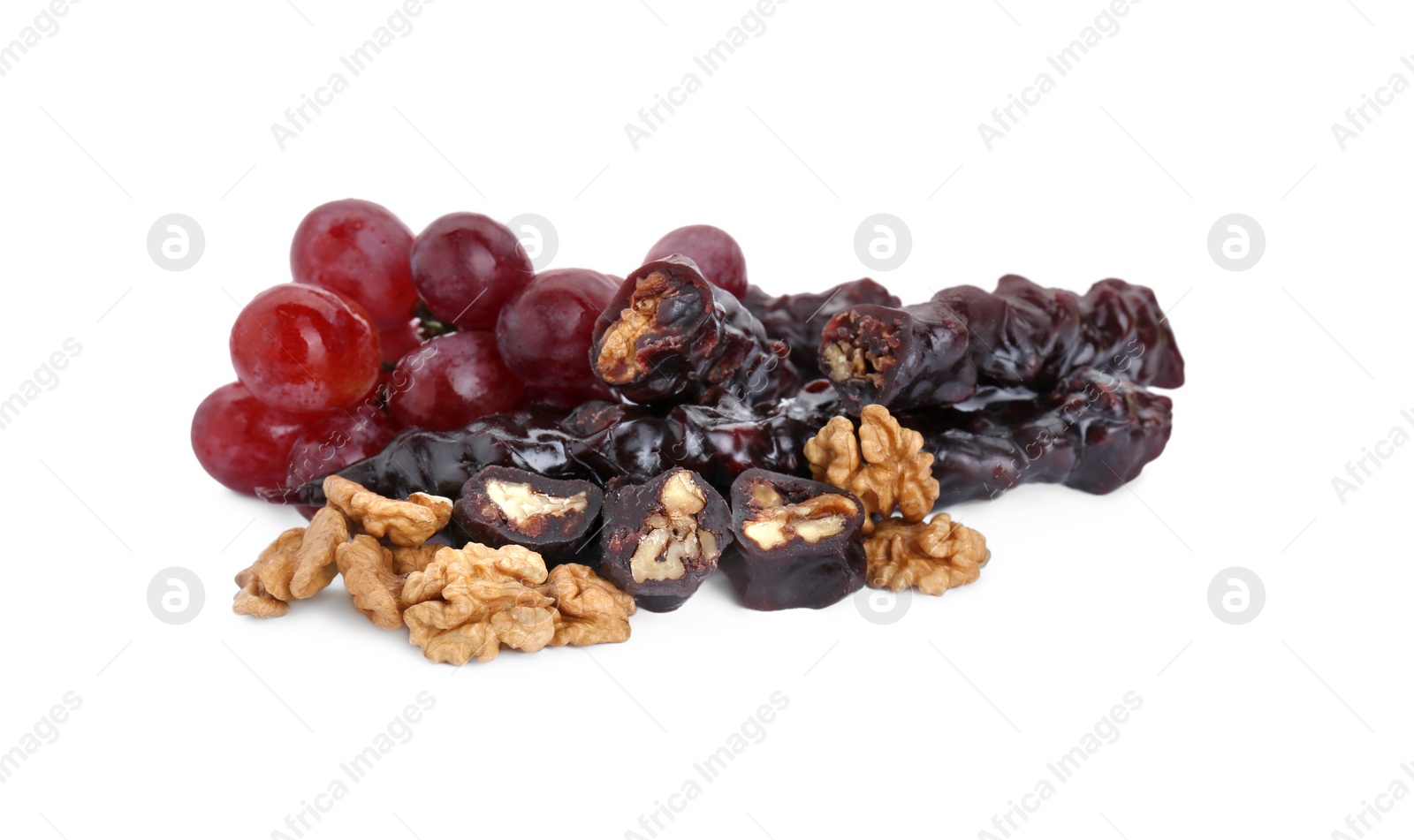 Photo of Delicious sweet churchkhelas with walnuts and grapes isolated on white