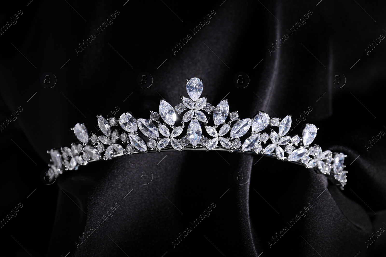 Photo of Beautiful silver tiara with diamonds on black cloth