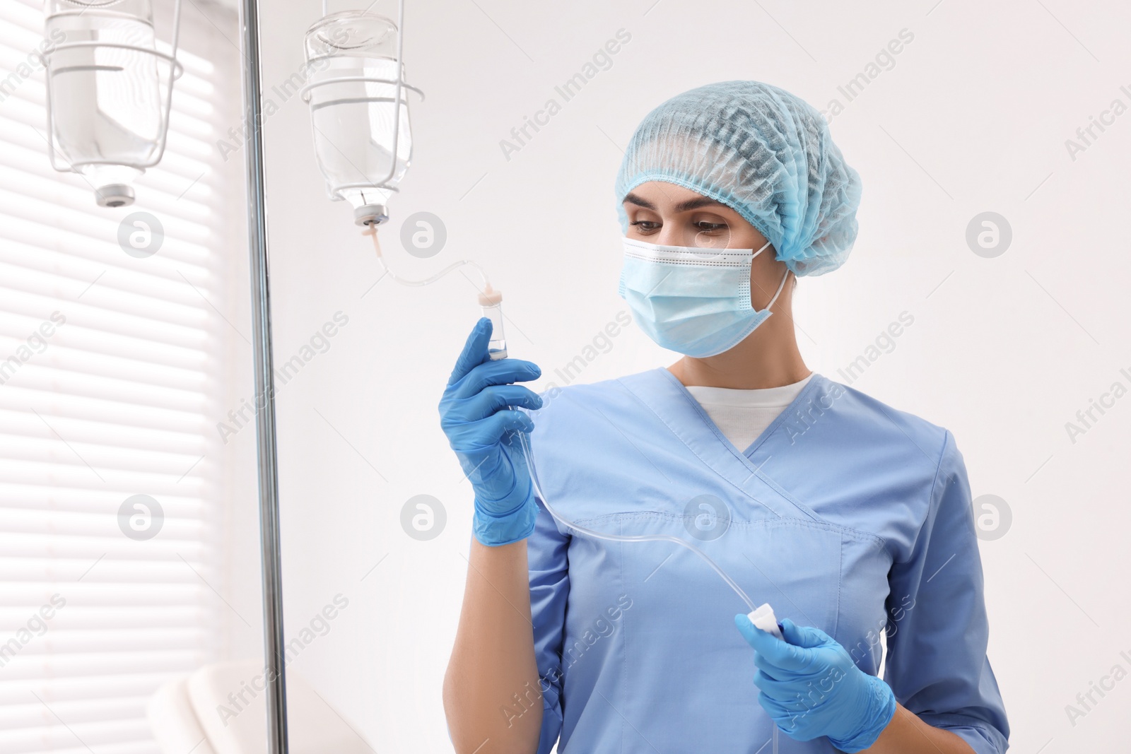 Photo of Nurse setting up IV drip in hospital