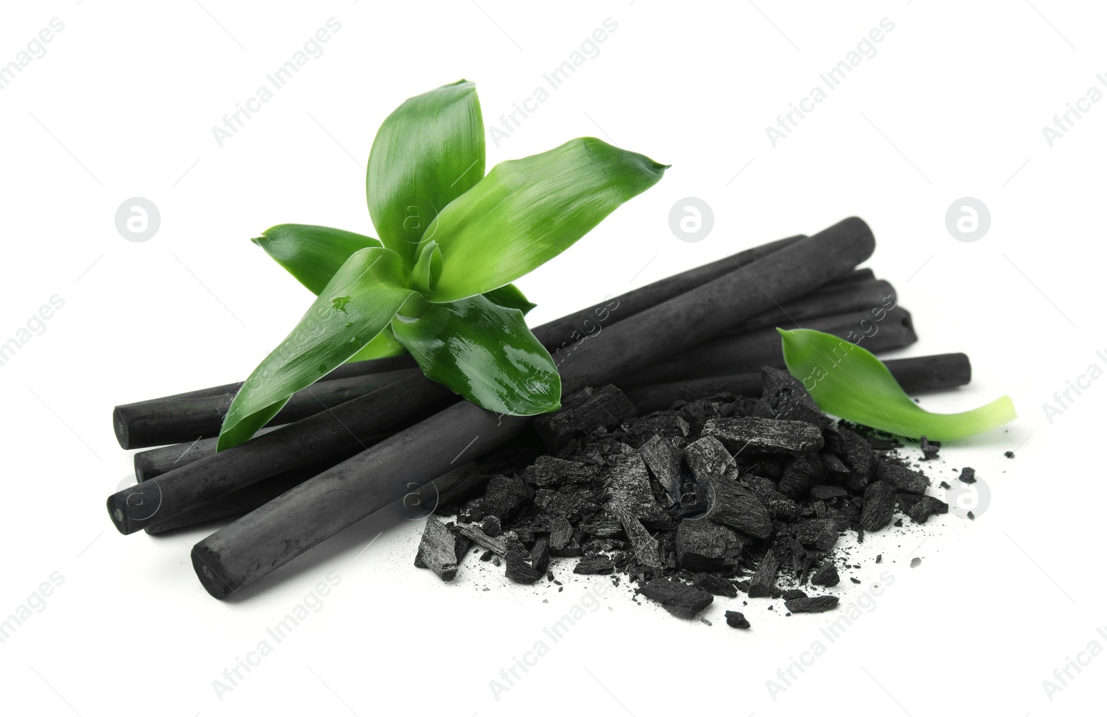 Photo of Fresh bamboo and charcoal on white background