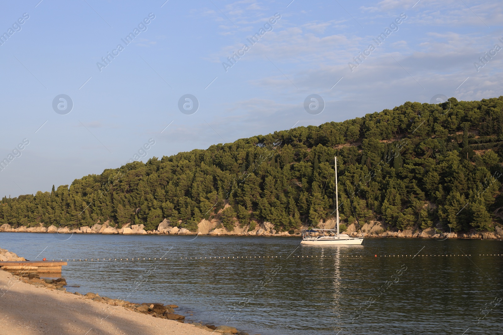 Photo of Beautiful view of tranquil sea and yacht on summer day