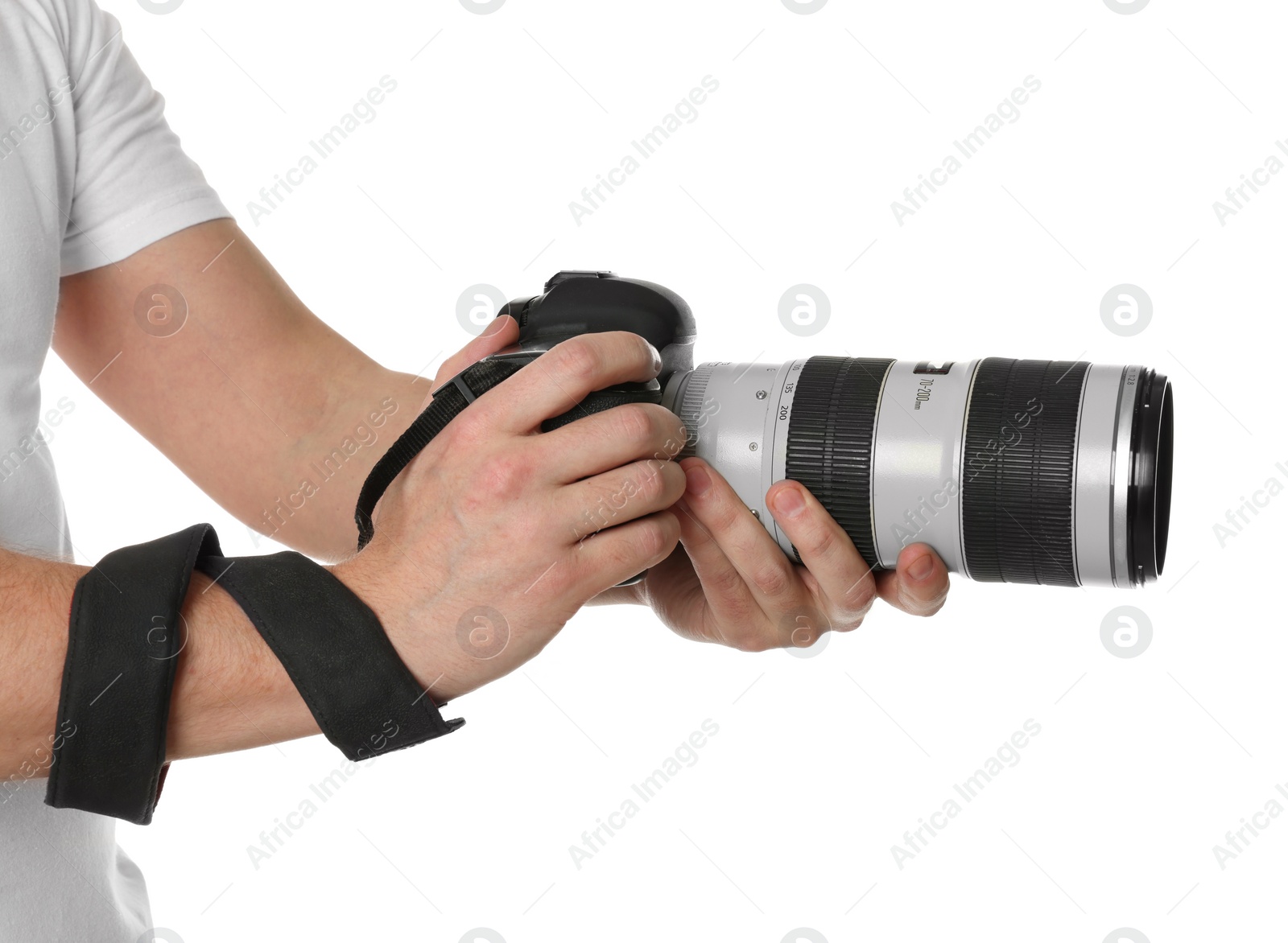 Photo of Photographer holding modern camera on white background, closeup