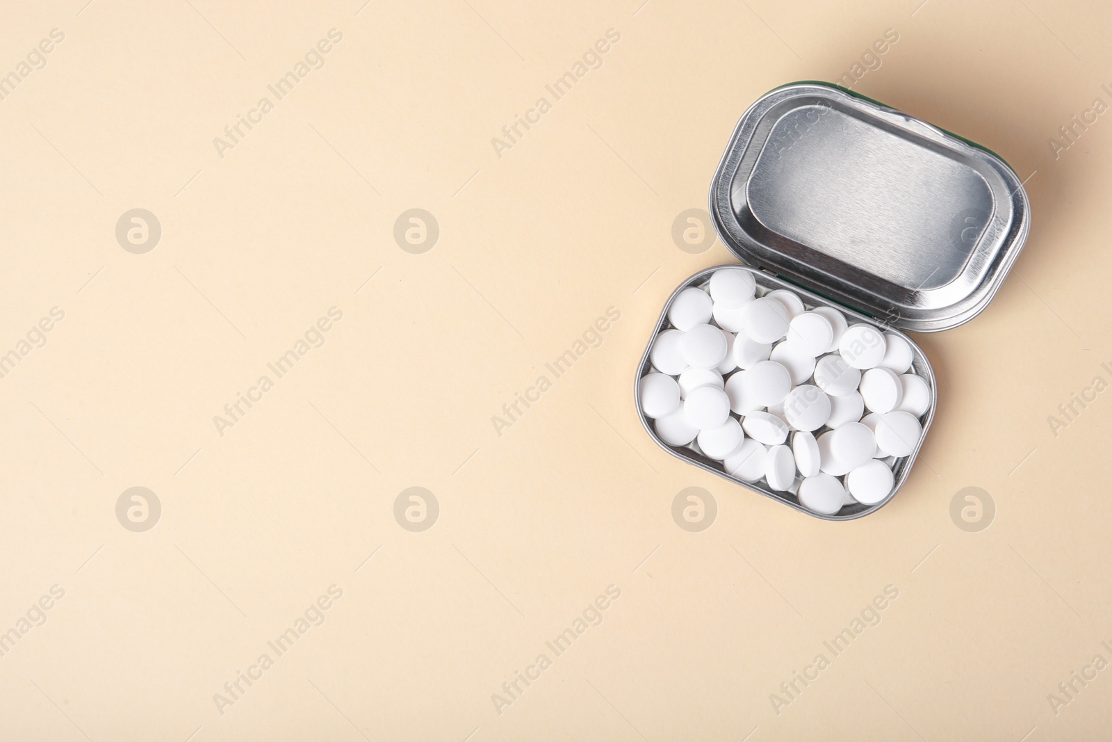 Photo of Open box with tasty mint candies on color background, top view