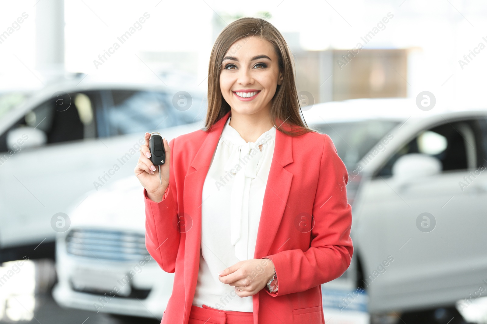 Photo of Young woman holding car key in salon