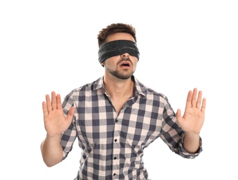 Young man with black blindfold on white background