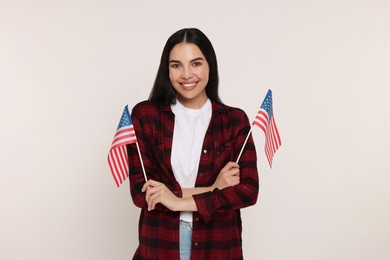 Photo of 4th of July - Independence Day of USA. Happy woman with American flags on white background