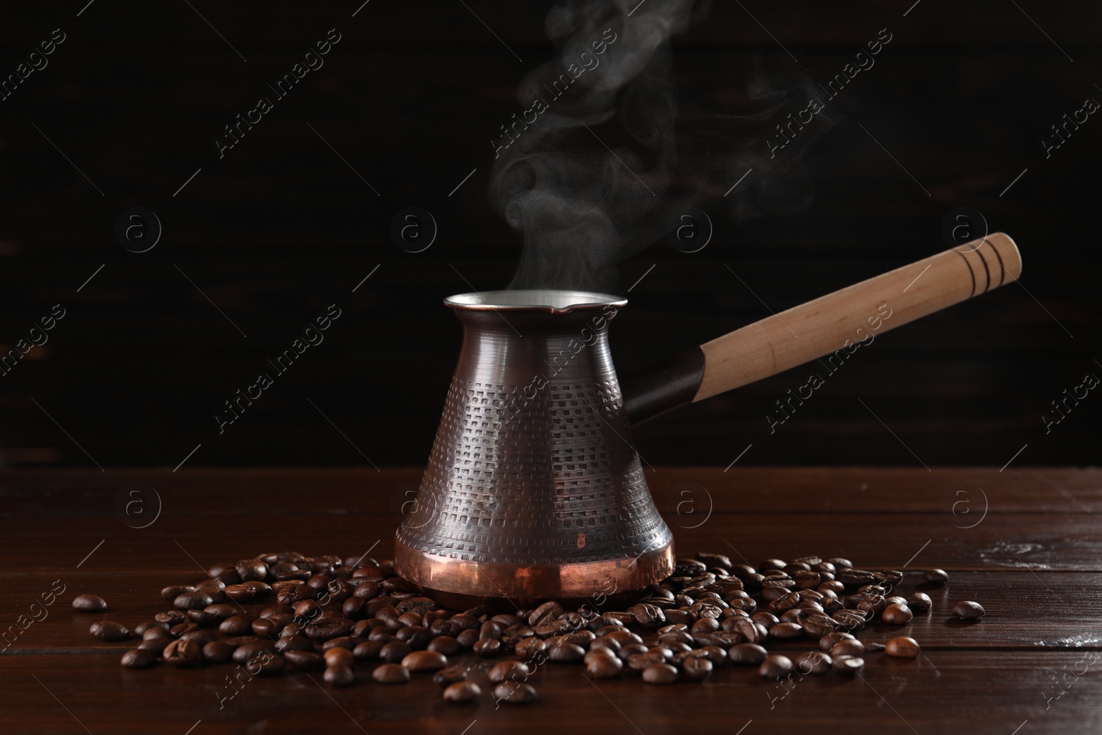 Photo of Turkish coffee in cezve and beans on wooden table