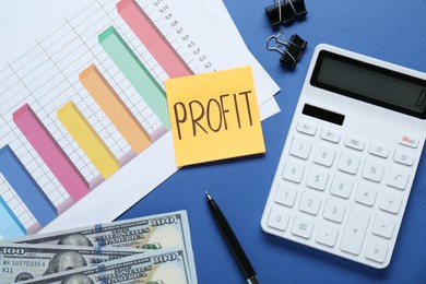 Photo of Sticky note with word Profit, diagram, banknotes and calculator on blue background, flat lay