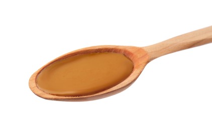 Photo of Wooden spoon with tasty peanut butter isolated on white