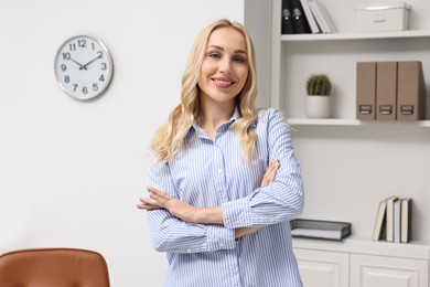 Portrait of happy beautiful secretary in office