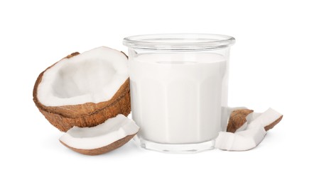 Glass of delicious vegan milk and coconut pieces on white background