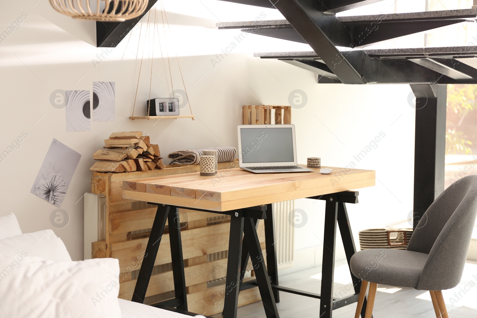 Photo of Elegant interior of room with workplace under stairs