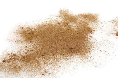 Photo of Pile of brown dust scattered on white background