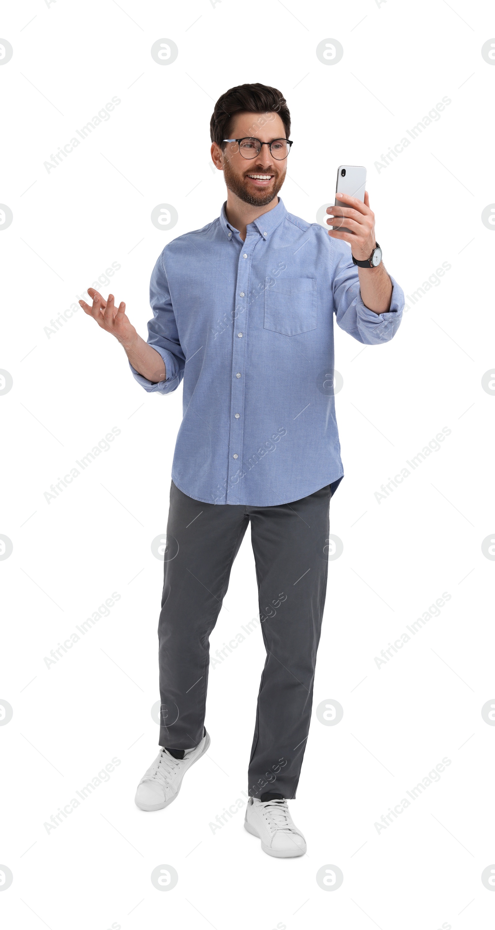 Photo of Smiling man taking selfie with smartphone on white background