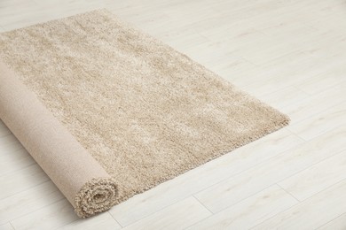 Rolled beige carpet on floor. Space for text