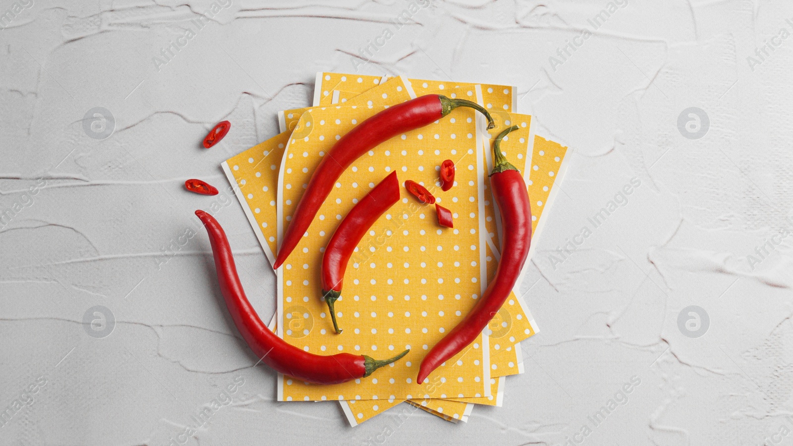 Photo of Pepper plasters and chili on white textured table, flat lay