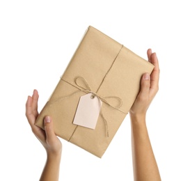 Photo of Woman holding parcel wrapped in kraft paper on white background, closeup