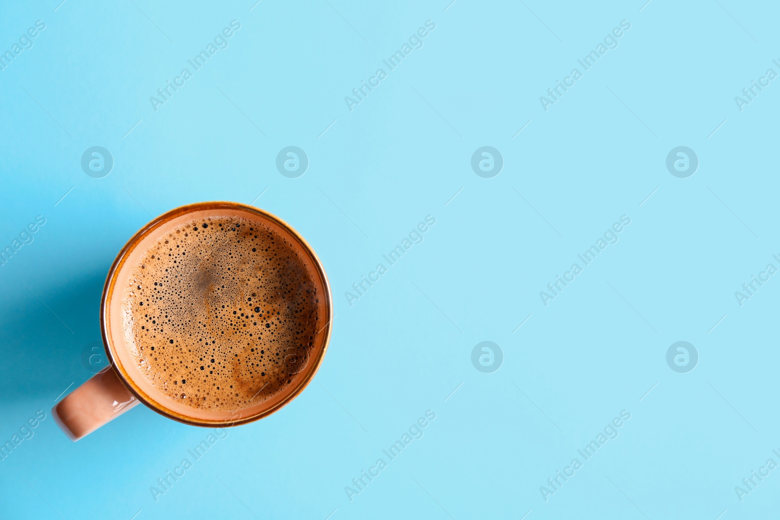 Photo of Cup of aromatic hot coffee on color background