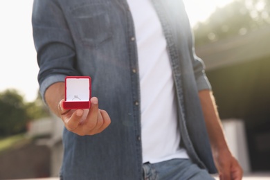 Photo of Man with beautiful engagement ring outdoors, closeup