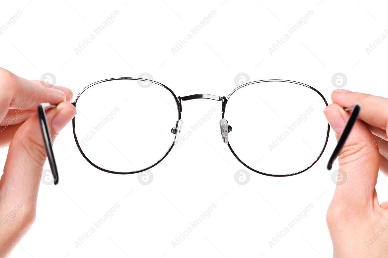 Photo of Woman holding stylish glasses with metal frame on white background, closeup