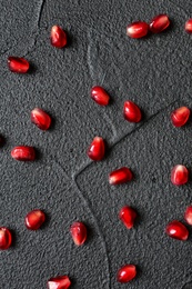 Fresh yummy pomegranate seeds on dark background