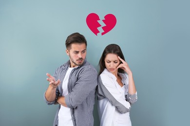 Image of Upset young couple and illustration of broken heart on color background. Relationship problems