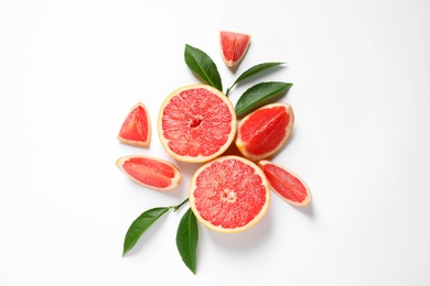 Photo of Grapefruits and leaves on white background, top view. Citrus fruits