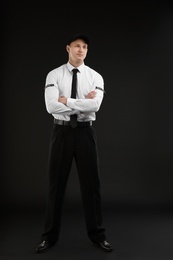 Photo of Male security guard in uniform on dark background