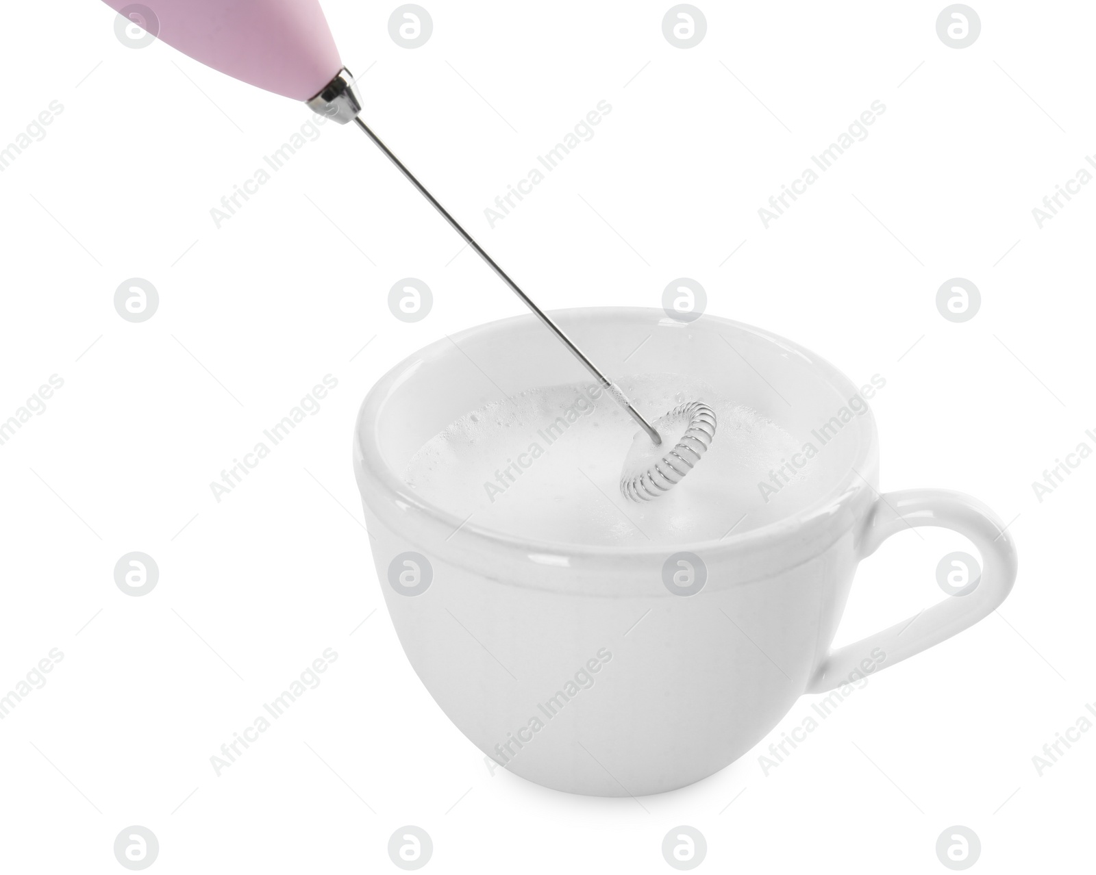 Photo of Whisking milk in cup with mini mixer (frother wand) isolated on white