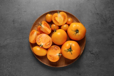 Photo of Fresh ripe yellow tomatoes on grey table, top view
