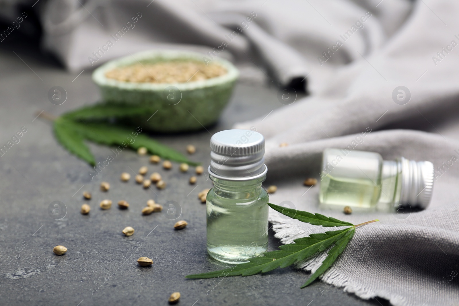 Photo of Bottles of hemp extract on grey table