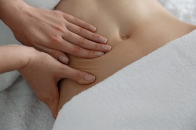 Woman receiving professional belly massage, closeup view