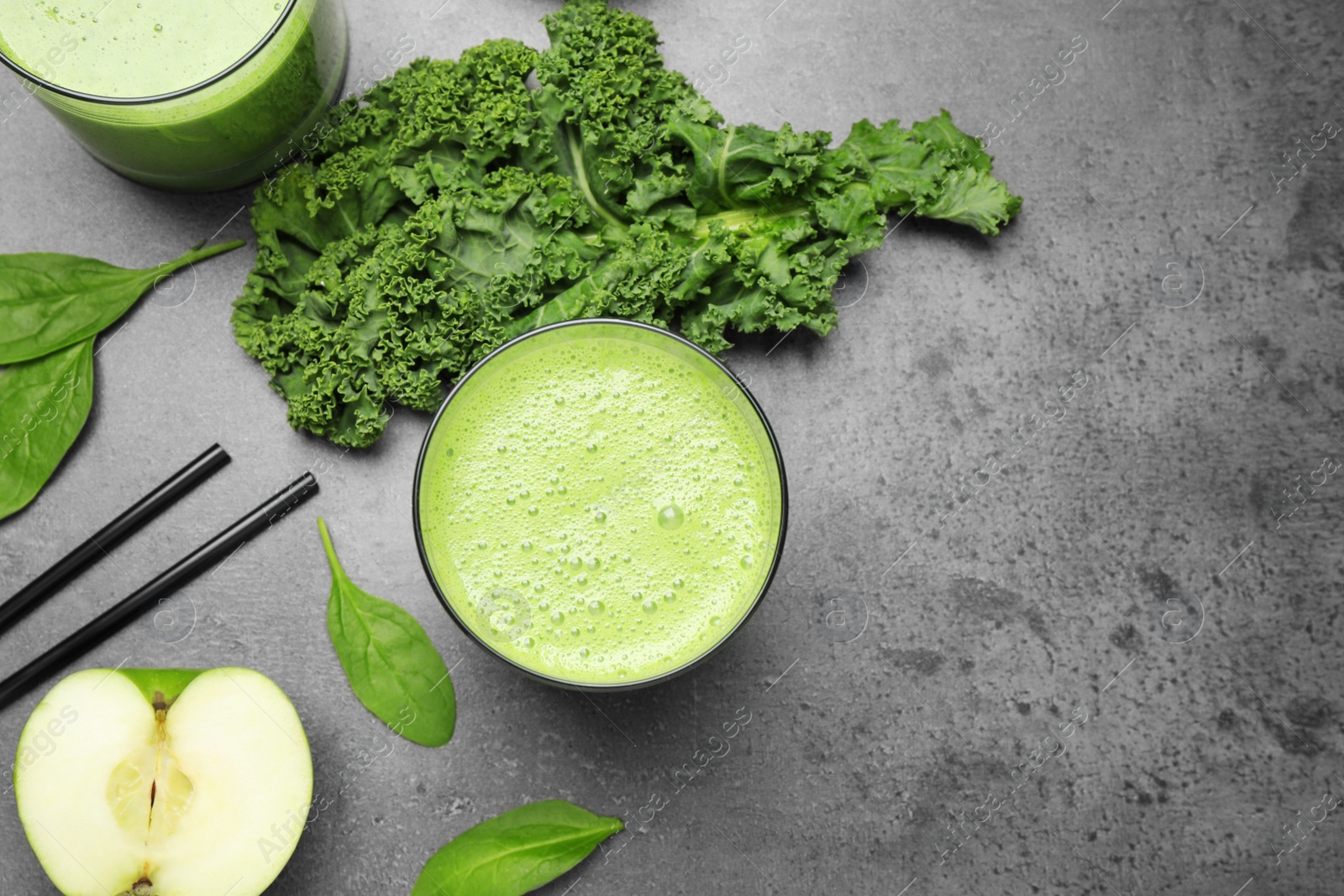 Photo of Flat lay composition with kale smoothie on grey table