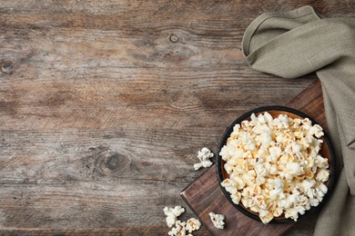 Photo of Flat lay composition with popcorn and space for text on wooden background