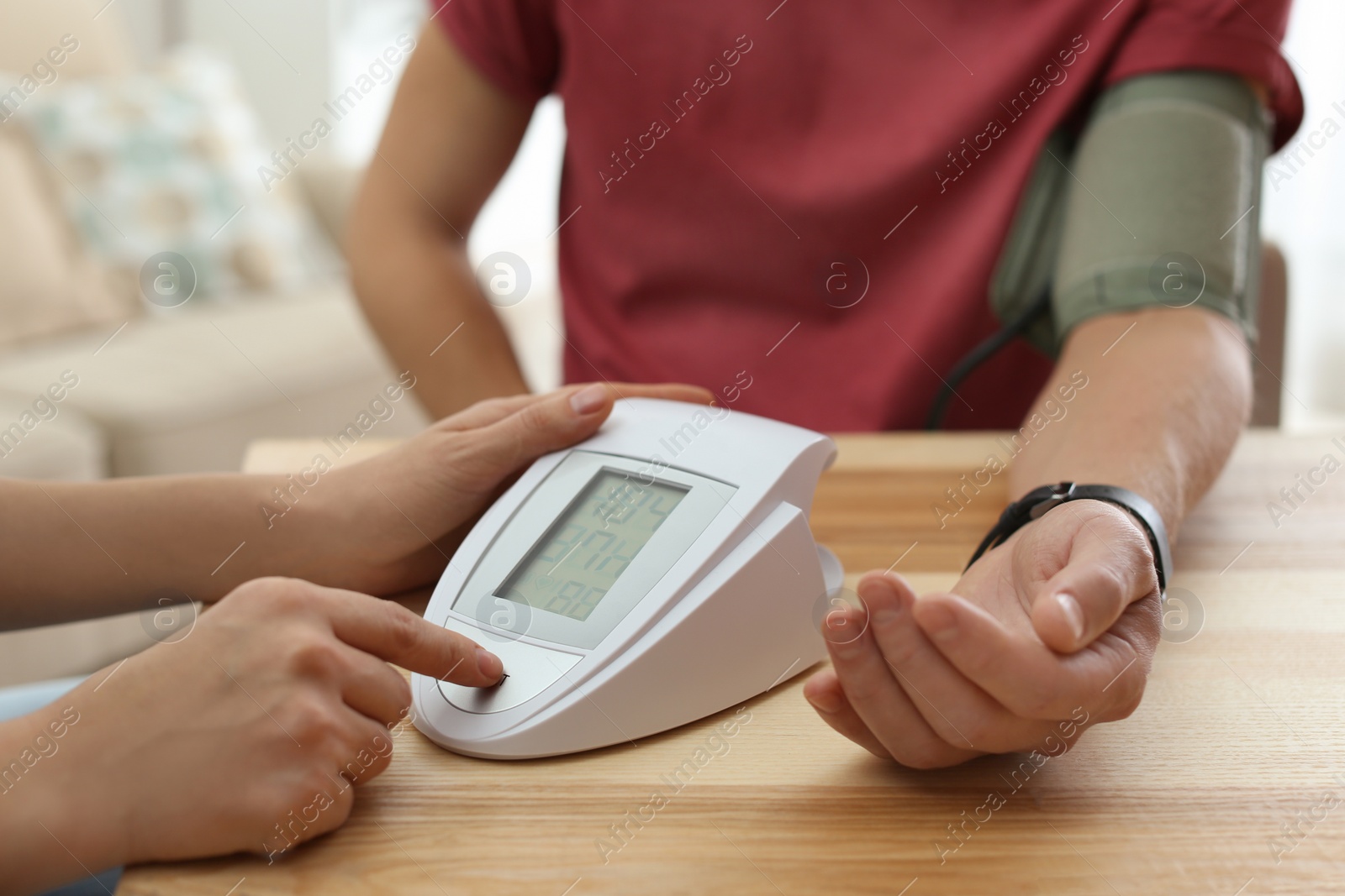 Photo of Doctor checking patient's blood pressure in hospital, closeup. Cardiology concept