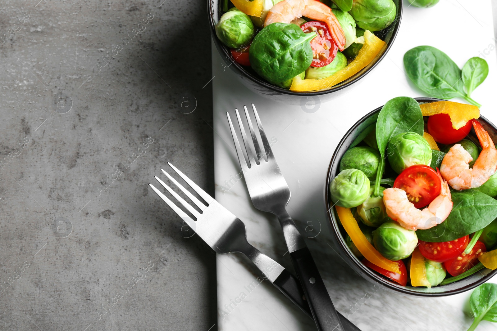 Photo of Tasty salad with Brussels sprouts served on grey table, flat lay