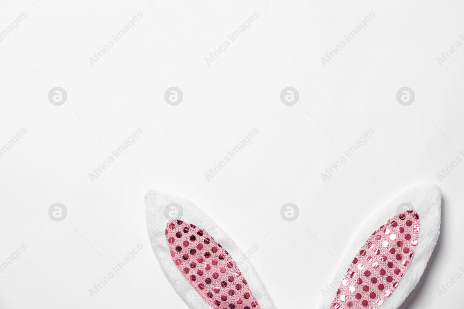 Photo of Funny Easter bunny ears on white background, top view