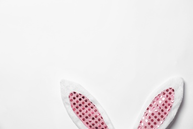 Photo of Funny Easter bunny ears on white background, top view