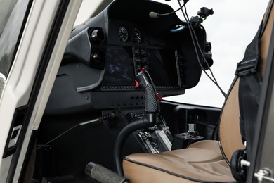 Photo of Helicopter cockpit with new modern functional panel and leather seat