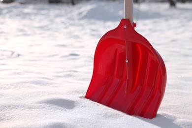 Photo of Snow shovel with wooden handle outdoors, closeup. Space for text